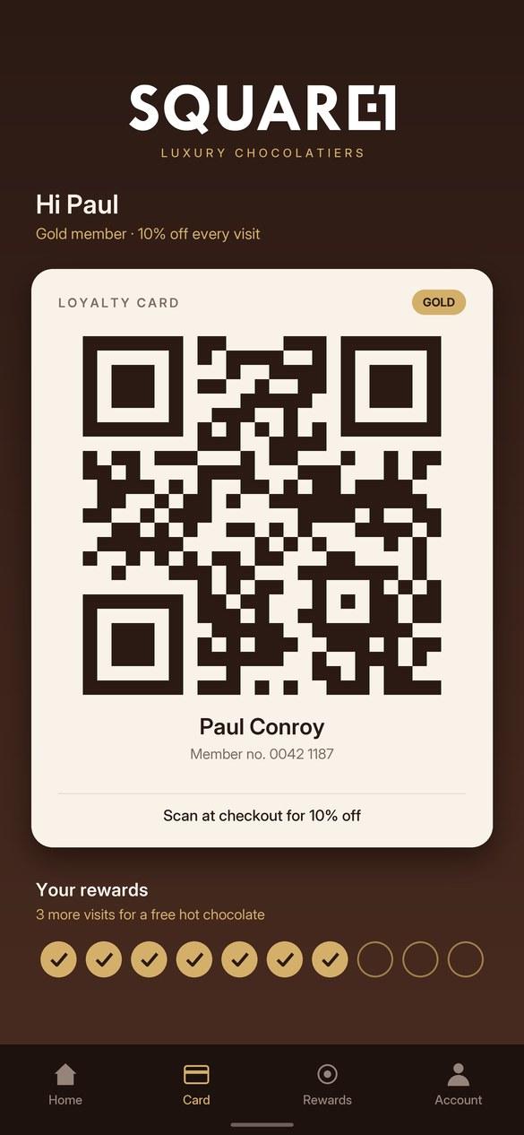 A phone screen showing a Square1 Luxury Chocolatiers gold loyalty card with a QR code, the name Paul Conroy, and seven of ten reward stamps collected