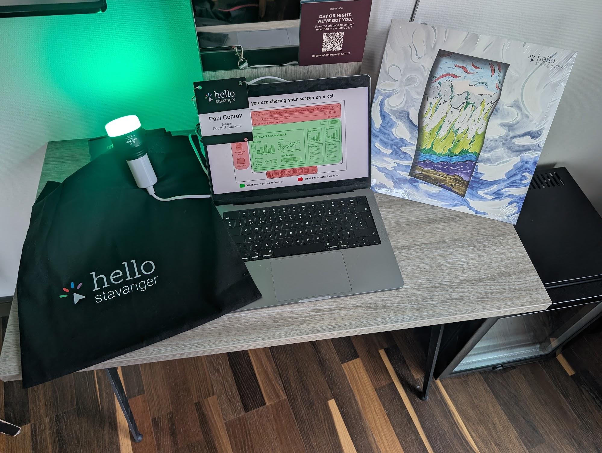 Bluetooth light bulb glowing green beside a laptop